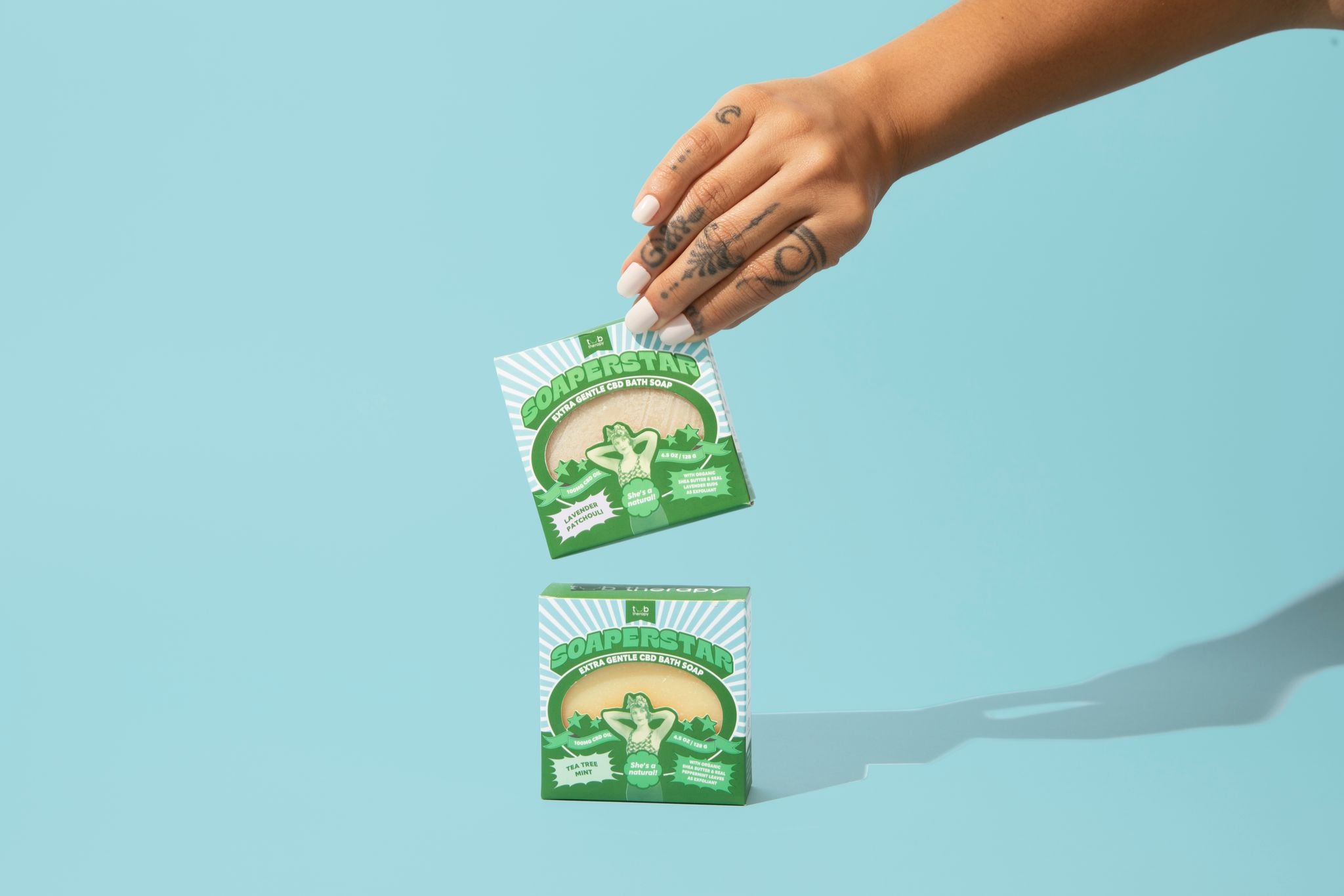 Hand holding a Tub Therapy Soaperstar Soap and another soap below it